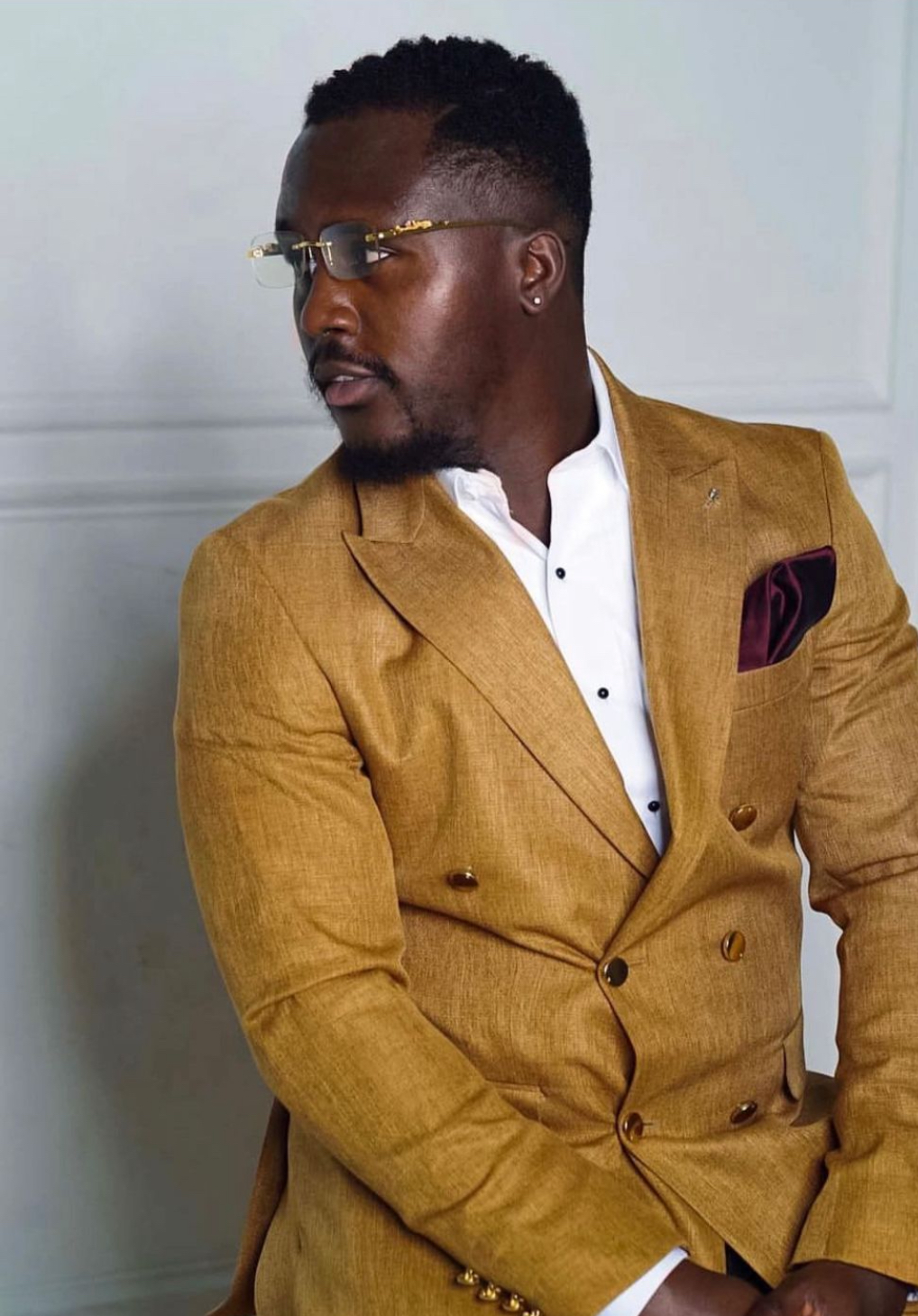 A sharply dressed man in a gold suit